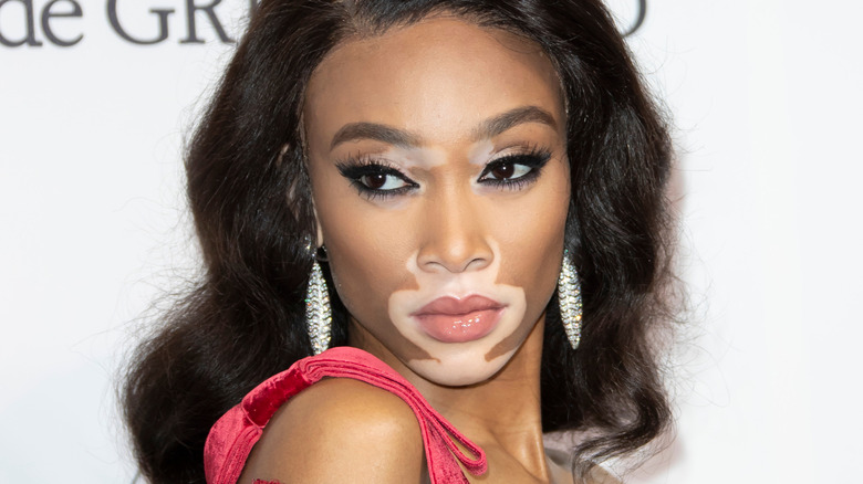 Winnie Harlow wearing dangling earrings