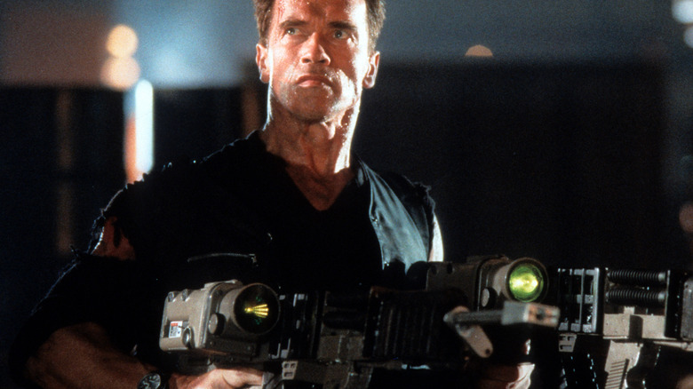 Arnold holds two big guns