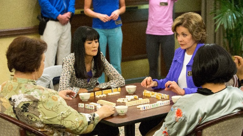 Lucille plays mahjong with the triads