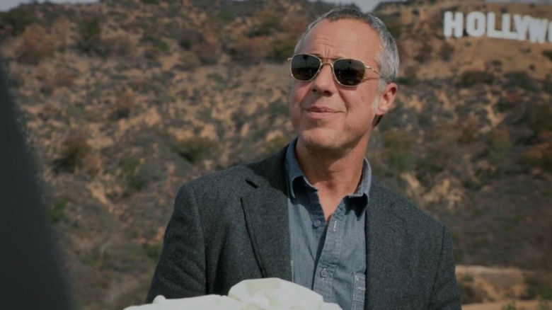 Bosch looks into the sun in front of the Hollywood sign in 