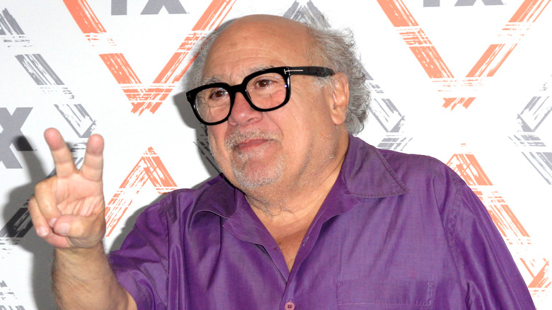 Danny DeVito making a peace sign