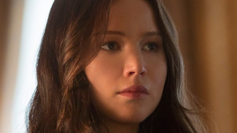 Katniss Everdeen stares pensively off to the side