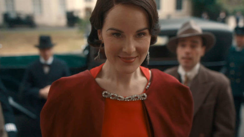 Mary in red with people behind her in "Downton Abbey: The Grand Finale" (2025)