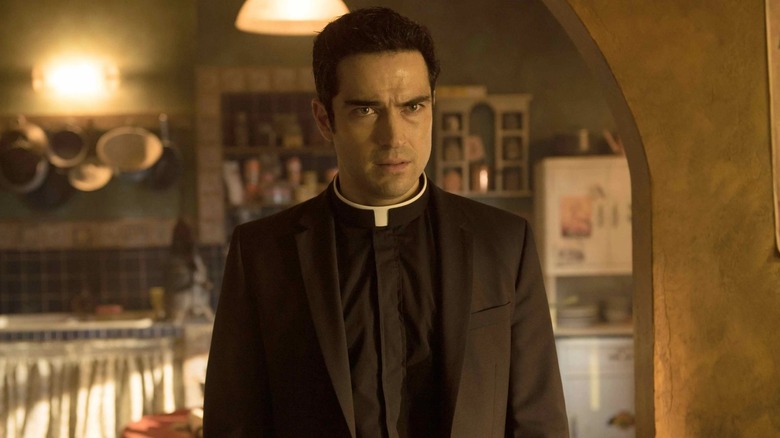 Father Thomas is framed by a stone doorway in The Exorcist TV series