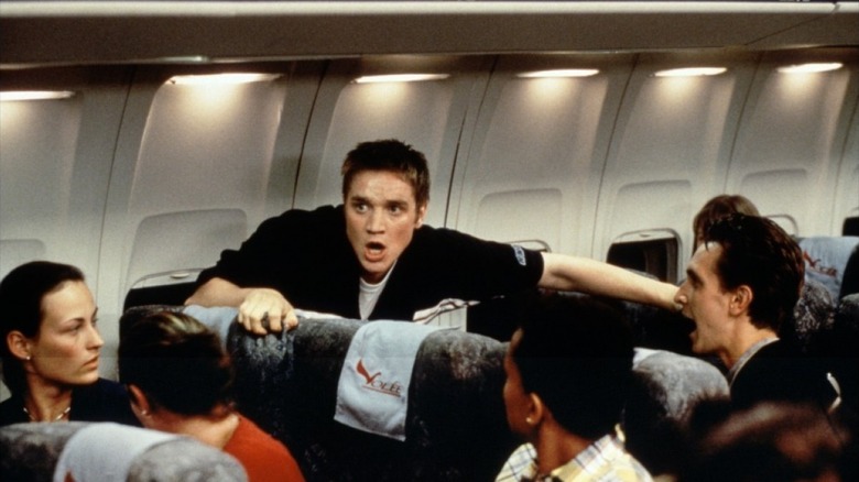 Alex warns everyone to get off the plane in "Final Destination" (2000)