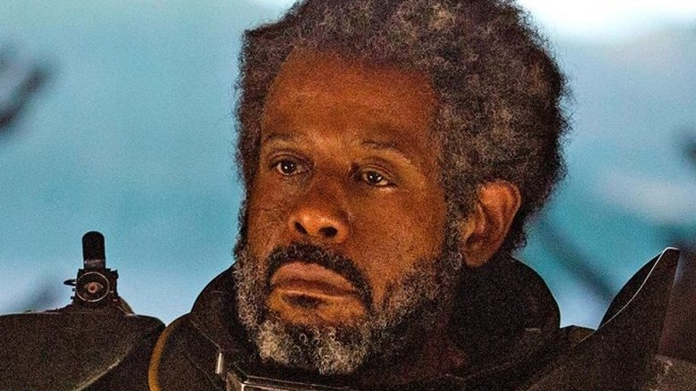 Saw Gerrera standing in front of window