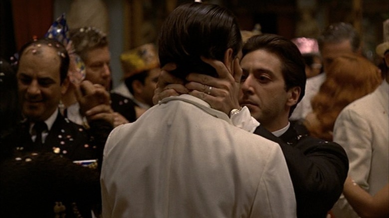 Al Pacino kissing John Cazale at a party