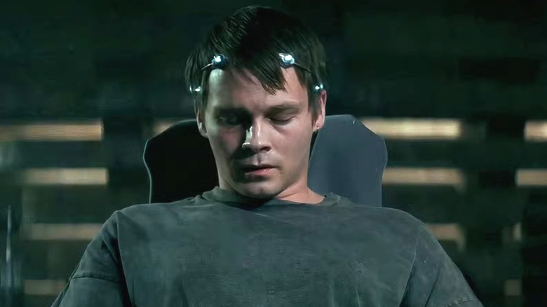 A man sitting in a chair with his eyes closed in "Nightflyers."