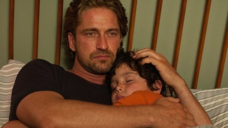 Gerard Butler holding kid