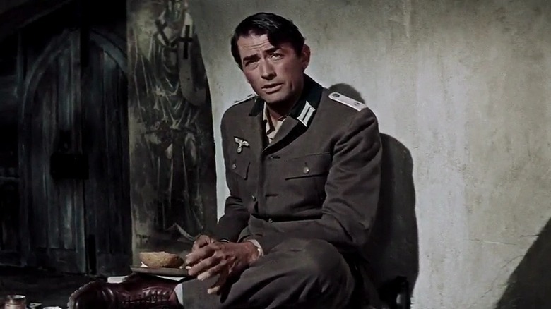 Mallory sits against a wall