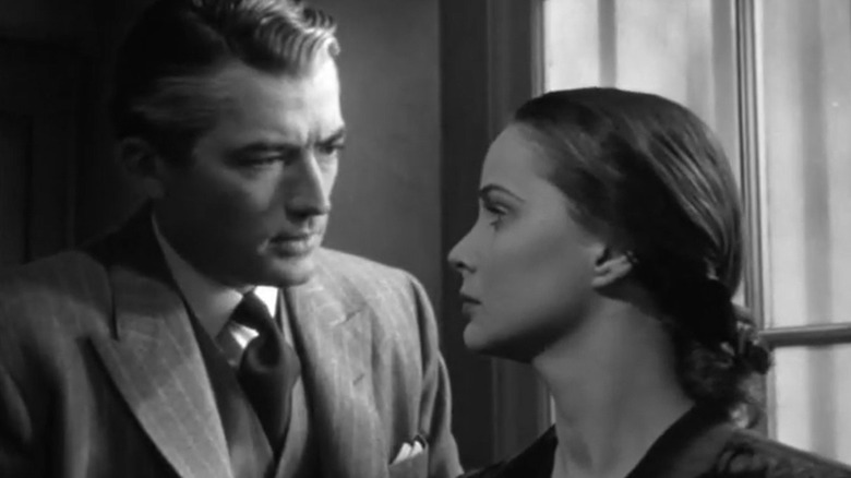 Keane talks to Mrs. Paradine by a window