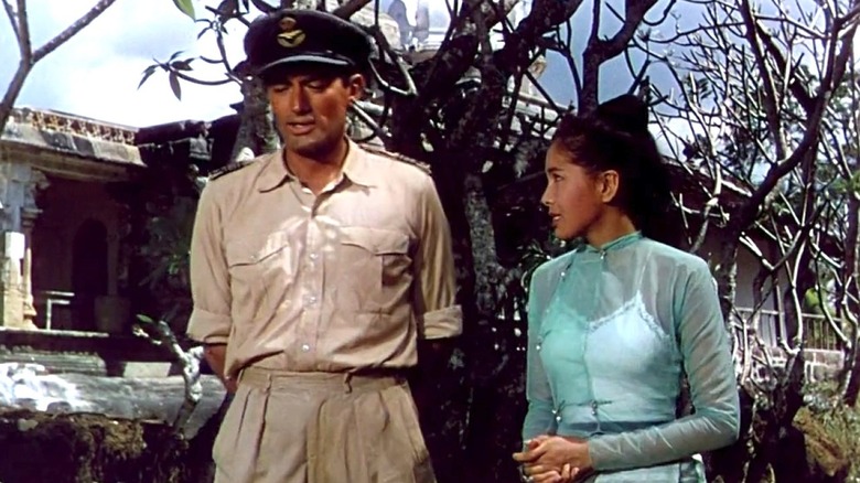 Forrester and Anna walk through a village