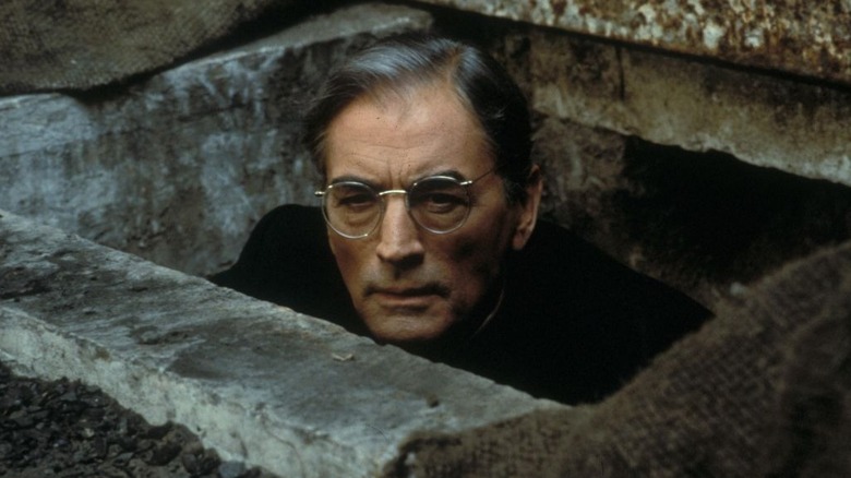 O'Flaherty peaks out from a stone wall