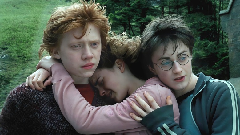 Harry, Ron, and Hermione looking very sad