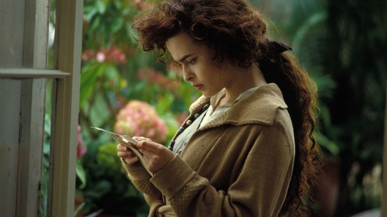 Helen squinting at a piece of paper in her hands
