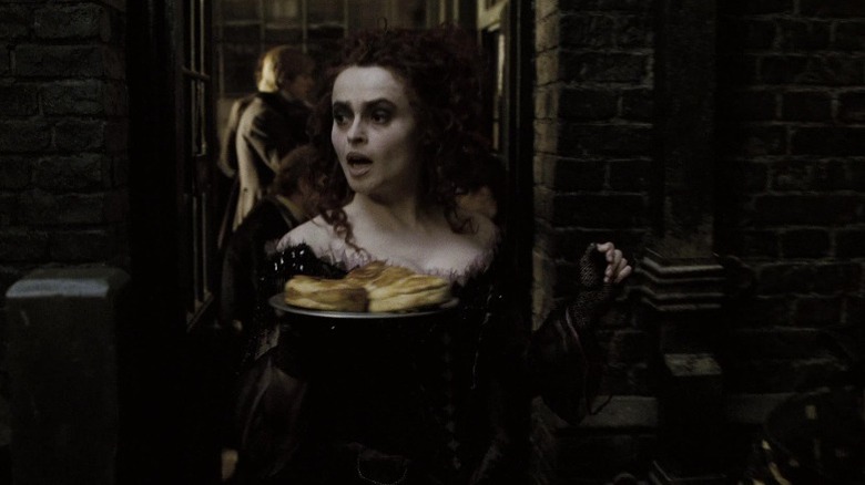 Mrs. Lovett holding a plate