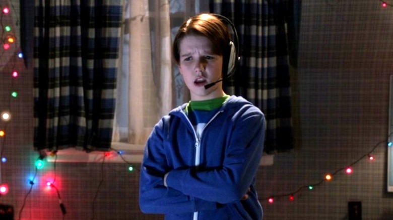 Finn stands in his bedroom while wearing a headset in Home Alone: The Holiday Heist (2012)