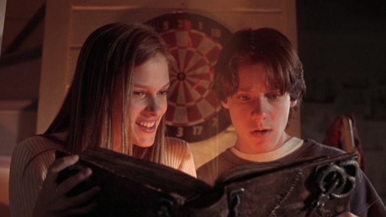 Max and Allison looking at the magic book