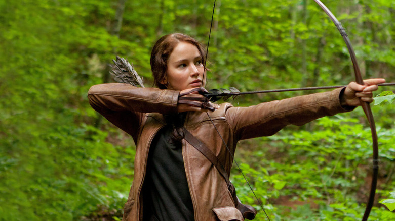 Katniss firing an arrow in The Hunger Games