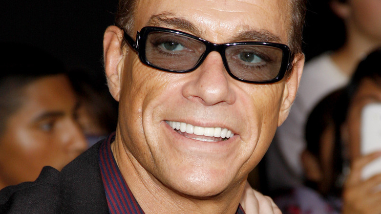 Jean-Claude Van Damme smiles at a premiere