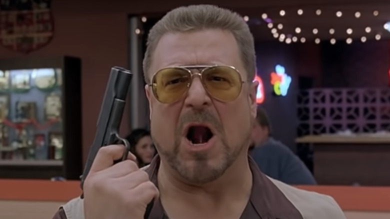 John Goodman yelling with gun