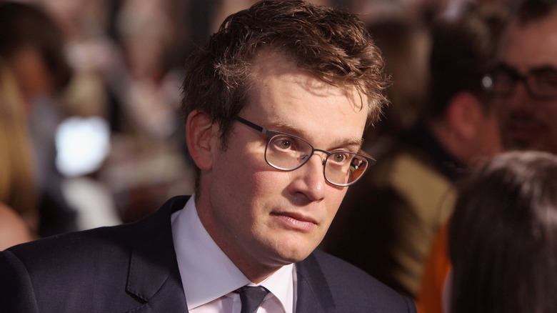 John Green wearing glasses and smiling