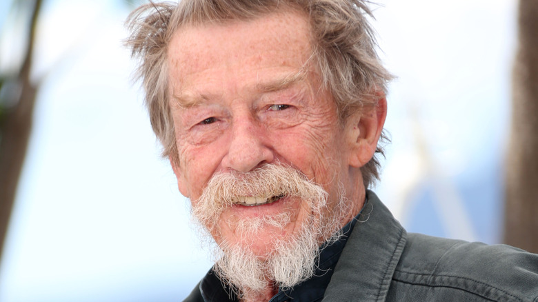 John Hurt smiles