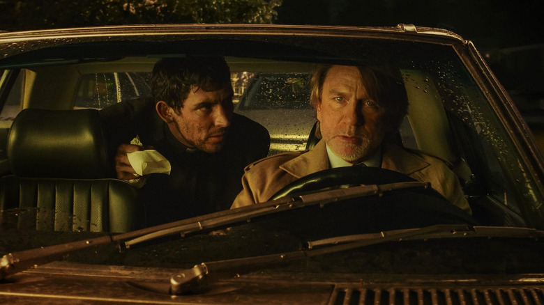 Father Jud and Benoit Blanc conversing in a car in "Wake Up Dead Man" (2025)