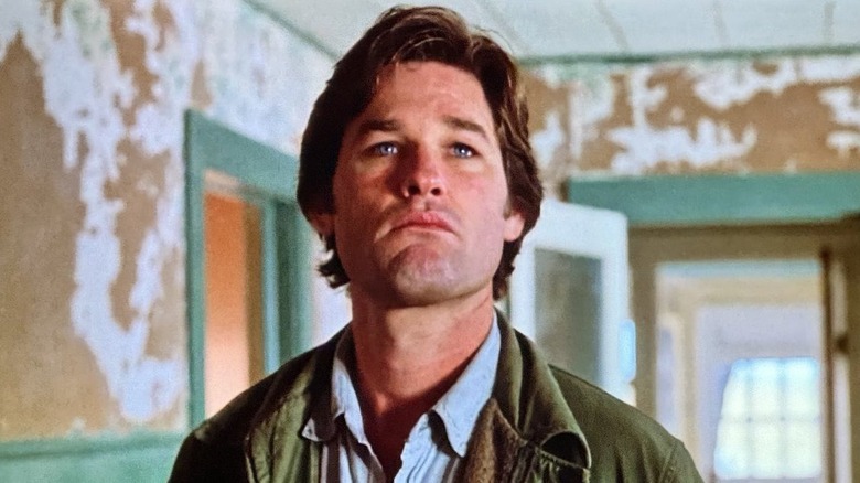 Drew Stephens walking through a rundown house