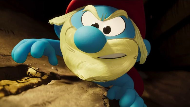 Ron Smurf climbs a mountain in "The Smurfs" (2025)