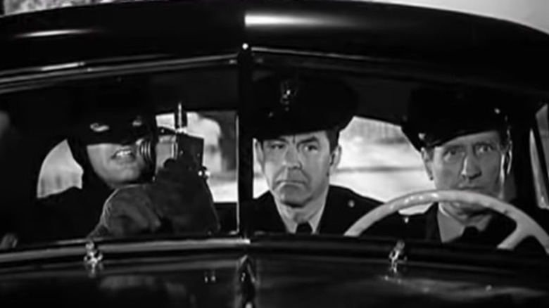 The Batman riding in a car