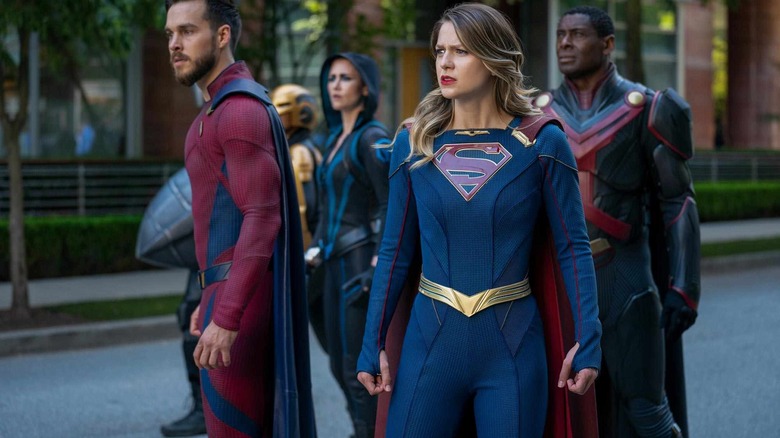 Supergirl standing with her superhero comrades in "Supergirl"