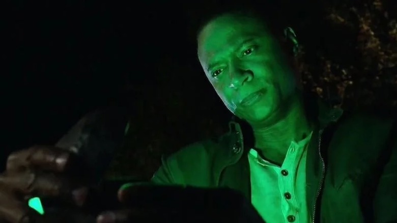 John Diggle looks at a glowing green light in "Arrow" (2012-2020)