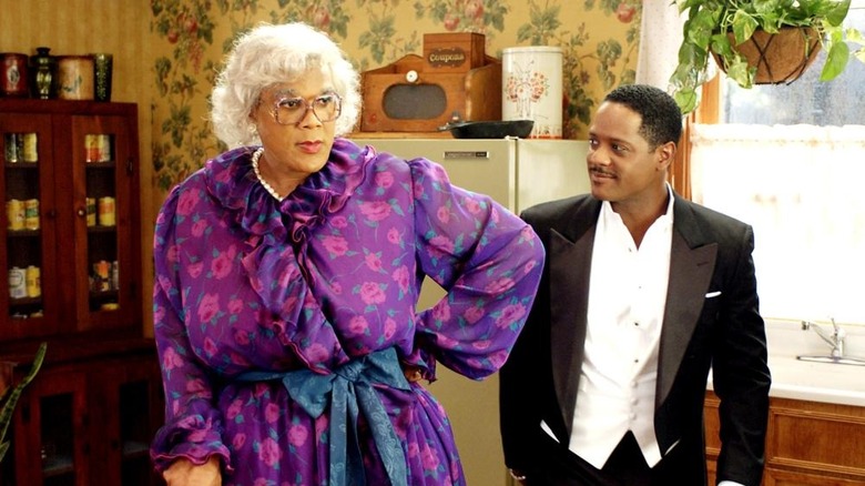 Madea standing in her kitchen dressed for a wedding with the groom
