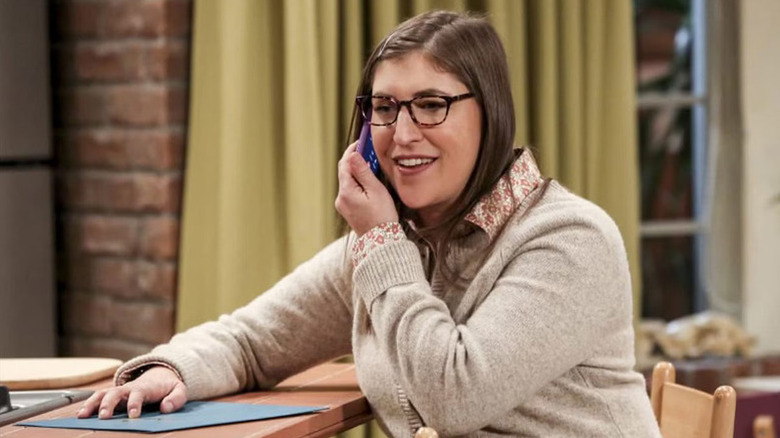Amy on the phone smiling on The Big Bang Theory