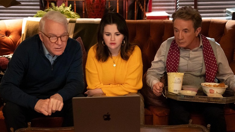 Mabel, Oliver, and Charles sitting around laptop in 
