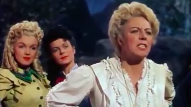 Monroe standing behind woman yelling 
