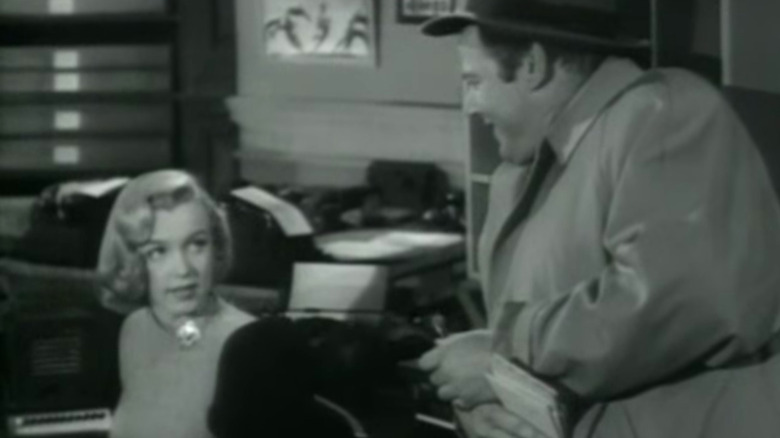 Monroe sitting at desk 