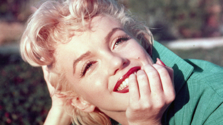 Monroe lying on grass smiling 