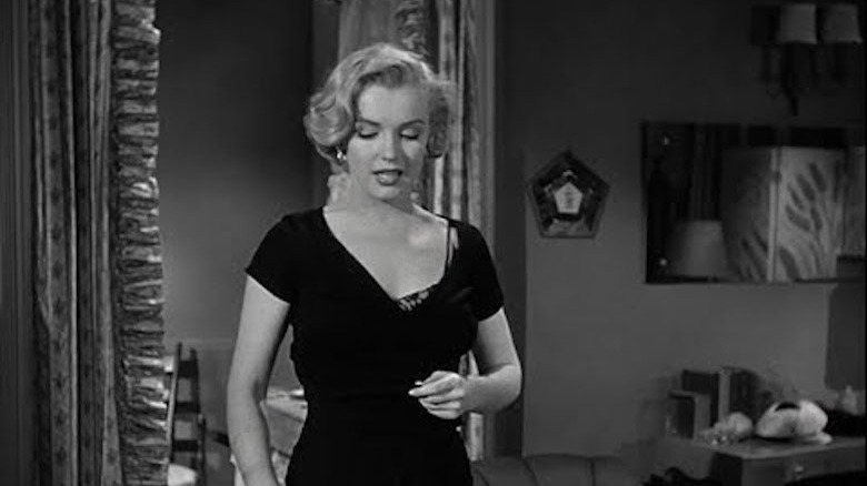 Monroe standing black dress in apartment 
