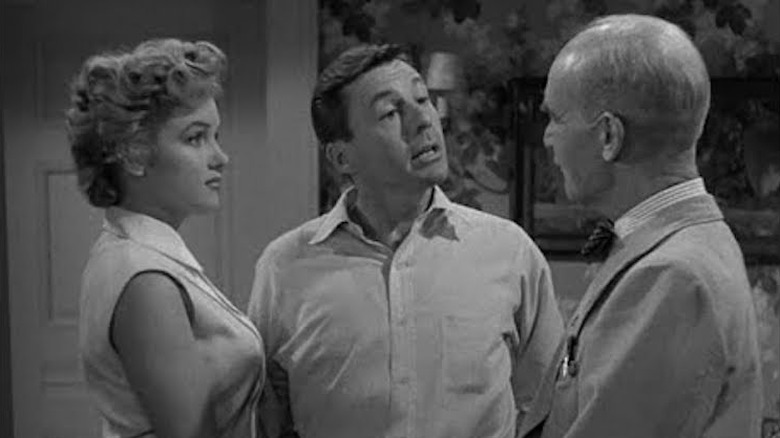 Monroe standing next to husband 