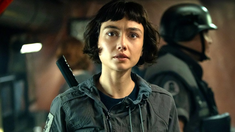 Wendy standing near an armed soldier in "Alien: Earth"