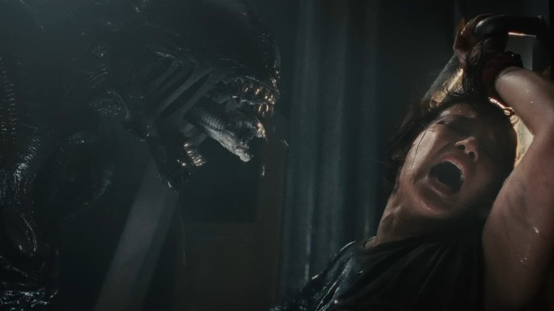 A Xenomorph lunges at Rain in Alien: Romulus
