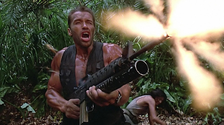 Dutch fires a huge machine gun in the jungle in Predator