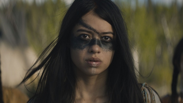 Nara with dark paint on her face looking forward in Prey