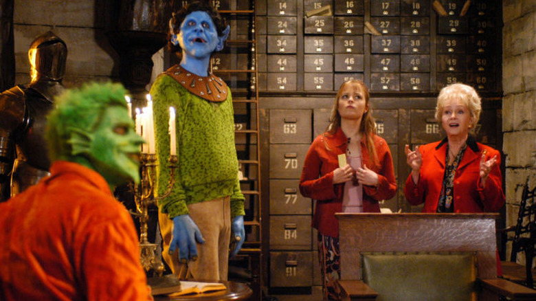 Marnie and Aggie in a library with two monsters in Halloweentown High (2004)