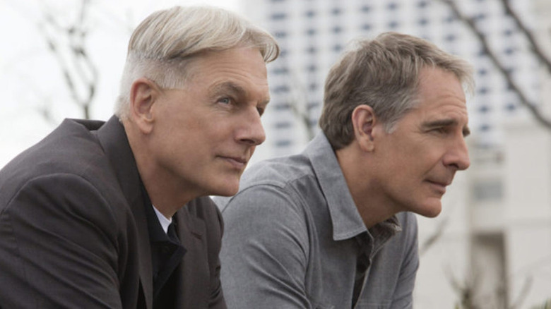 Gibbs and Pride lean over a railing in 