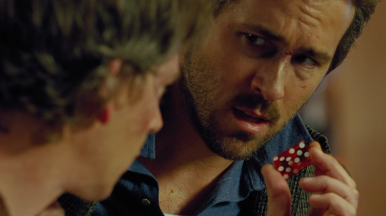 Ryan Reynolds shows Ben Mendelsohn dice