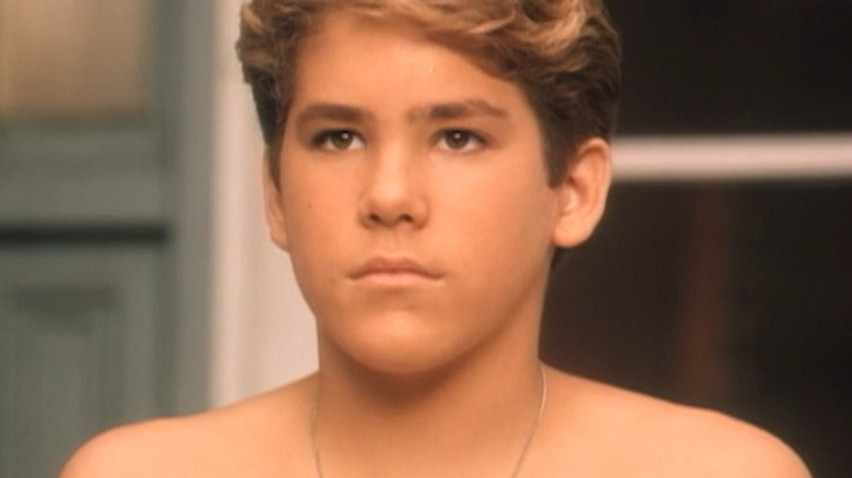 A teenage Ryan Reynolds sits in protest