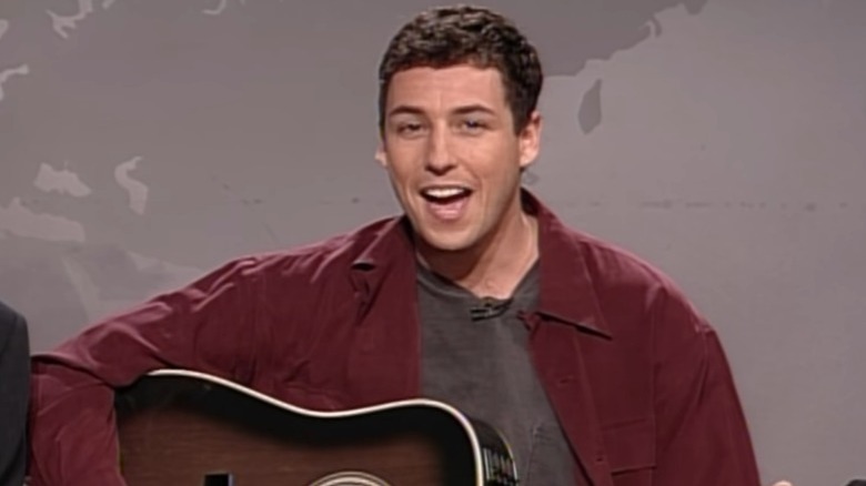 Adam Sandler playing guitar